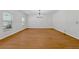 Large living room with hardwood floors, lots of light, and modern chandelier at 7431 St David St, Fairburn, GA 30213