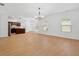 Large living room with hardwood floors, modern lighting and lots of natural light at 7431 St David St, Fairburn, GA 30213
