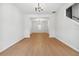 Bright living room showcasing wood-look flooring and a view into the entryway and stairs at 7431 St David St, Fairburn, GA 30213