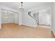 Bright living room featuring open archways, neutral walls, hardwood floors and stylish lighting at 7431 St David St, Fairburn, GA 30213