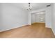 Large, open living room featuring hardwood floors, neutral walls, and modern lighting at 7431 St David St, Fairburn, GA 30213