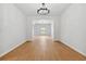 Spacious living room showcasing wood-look flooring, neutral walls, and a view into another room at 7431 St David St, Fairburn, GA 30213