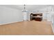 Spacious open-concept living room with wood floors and contemporary chandelier at 7431 St David St, Fairburn, GA 30213
