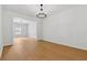 Bright living room featuring wood-look flooring and view into an adjacent dining space at 7431 St David St, Fairburn, GA 30213