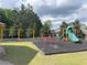 Community playground area featuring swings, slides, and soft ground covering at 7431 St David St, Fairburn, GA 30213