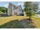 Well-maintained side yard, with green grass and a partial view of the home's exterior at 7431 St David St, Fairburn, GA 30213