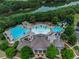 Aerial view of community pool, clubhouse, and lake, surrounded by lush trees at 924 Woodbury Rd, Canton, GA 30114