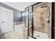 Modern bathroom featuring tiled shower, soaking tub, and neutral color palette at 924 Woodbury Rd, Canton, GA 30114