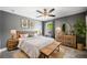 Comfortable bedroom with ceiling fan, bedside lamps, area rug, and curated decorations at 924 Woodbury Rd, Canton, GA 30114