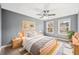 Comfortable bedroom with ceiling fan, bedside lamps, and lots of natural light at 924 Woodbury Rd, Canton, GA 30114