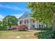 Exterior view of the Heritage Club featuring a well-manicured lawn and classic architecture with large white columns at 924 Woodbury Rd, Canton, GA 30114