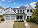 Charming two-story home with a well-manicured lawn, a two-car garage, and a welcoming front porch at 924 Woodbury Rd, Canton, GA 30114