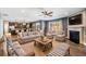Spacious living room featuring hardwood floors, fireplace, ceiling fan, and plenty of natural light at 924 Woodbury Rd, Canton, GA 30114