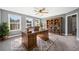 Bright office with large desk, decorative rug, natural light, and ample book storage at 924 Woodbury Rd, Canton, GA 30114