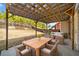 Outdoor patio with pergola, dining table and chairs, sofa, and green yard space at 924 Woodbury Rd, Canton, GA 30114