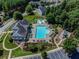 Community pool with lounge chairs, playground and clubhouse, all surrounded by lush landscaping and ample parking at 924 Woodbury Rd, Canton, GA 30114