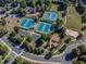 Aerial view of community tennis courts, playground, basketball court, and green space with walking paths at 924 Woodbury Rd, Canton, GA 30114