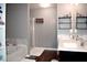 Stylish bathroom with double vanity, soaking tub, separate shower, and decorative shelving at 1058 Mays Sw Hl, Atlanta, GA 30336