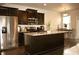 Modern kitchen featuring dark cabinets, stainless steel appliances, and a spacious island with seating at 1058 Mays Sw Hl, Atlanta, GA 30336