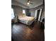 This main bedroom features dark hardwood flooring, a ceiling fan and neutral decor at 1058 Mays Sw Hl, Atlanta, GA 30336