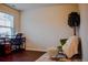 Bright and airy office space with a desk, chair, and a cozy sitting area near a large window at 1058 Mays Sw Hl, Atlanta, GA 30336