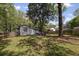 Grassy backyard featuring a fire pit with wooden chairs, perfect for relaxing and entertaining with a wooden privacy fence at 1089 Greenleaf Se Rd, Atlanta, GA 30316