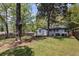 Expansive backyard offers ample green space, a fire pit, and a wooden fence for privacy, making it ideal for Gathering gatherings at 1089 Greenleaf Se Rd, Atlanta, GA 30316
