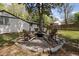 Cozy backyard features a stone-ringed fire pit area, perfect for outdoor entertaining and relaxation with wooden adirondack chairs at 1089 Greenleaf Se Rd, Atlanta, GA 30316