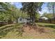 Spacious backyard offers a tranquil setting with mature trees and a charming fire pit area, perfect for enjoying outdoor living at 1089 Greenleaf Se Rd, Atlanta, GA 30316