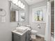 Bathroom features a modern vanity, decorative vessel sink, a large mirror, updated fixtures, and a shower-tub combo at 1089 Greenleaf Se Rd, Atlanta, GA 30316