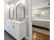 Bathroom featuring a double sink vanity with modern fixtures and arched mirrors at 1089 Greenleaf Se Rd, Atlanta, GA 30316