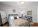 Bright bedroom with hardwood floors, neutral paint, modern lighting, stylish decor, and a work desk for convenience at 1089 Greenleaf Se Rd, Atlanta, GA 30316