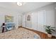 Bedroom features hardwood floors, neutral paint, closet, modern lighting, stylish decor, and a work desk for convenience at 1089 Greenleaf Se Rd, Atlanta, GA 30316