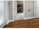 Hallway features wood floors, neutral paint, open doorway, and a storage shelf for a functional and stylish space at 1089 Greenleaf Se Rd, Atlanta, GA 30316