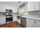 Charming kitchen featuring white cabinets, subway tile backsplash, stainless steel appliances, and hardwood floors at 1089 Greenleaf Se Rd, Atlanta, GA 30316