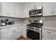 Bright kitchen featuring white cabinetry, stainless steel appliances, quartz countertops, and hardwood floors at 1089 Greenleaf Se Rd, Atlanta, GA 30316