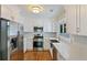 Well-lit kitchen boasts stainless steel appliances, white cabinetry, subway tile backsplash, and a farmhouse sink at 1089 Greenleaf Se Rd, Atlanta, GA 30316