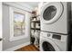 Laundry room features a stackable washer and dryer, ample shelving, and a window for a bright and functional space at 1089 Greenleaf Se Rd, Atlanta, GA 30316
