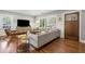 Inviting living room featuring hardwood floors, a large window, and a comfortable sofa at 1089 Greenleaf Se Rd, Atlanta, GA 30316