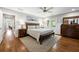 Cozy main bedroom featuring hardwood floors, a ceiling fan, and a large wooden bed at 1089 Greenleaf Se Rd, Atlanta, GA 30316