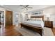 Spacious bedroom with a ceiling fan, a wooden bed frame, and a barn door leading to an ensuite at 1089 Greenleaf Se Rd, Atlanta, GA 30316