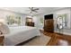 Bright main bedroom featuring hardwood floors, natural light, a ceiling fan, and stylish furniture at 1089 Greenleaf Se Rd, Atlanta, GA 30316
