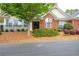 Charming brick home featuring a landscaped front yard, black trim windows, and manicured bushes at 1535 Duluth Hwy # 1104, Lawrenceville, GA 30043