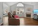 Spacious living room with hardwood floors, a large window, a fireplace, and comfortable seating at 1535 Duluth Hwy # 1104, Lawrenceville, GA 30043