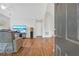 Open-concept living room with hardwood floors, neutral walls, and view of television and recliner at 1535 Duluth Hwy # 1104, Lawrenceville, GA 30043