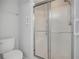 Bathroom featuring toilet and walk in shower with glass doors at 1535 Duluth Hwy # 1104, Lawrenceville, GA 30043