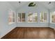 Bright sun room featuring hardwood floors, plenty of natural light, and views of the backyard at 1535 Duluth Hwy # 1104, Lawrenceville, GA 30043