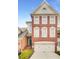 Charming brick townhome with a two-car garage and well-maintained landscaping at 195 Mystic Ct, Atlanta, GA 30342