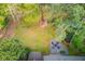 Aerial shot of backyard with play area, and fire pit at 657 Swans Landing Dr, Dacula, GA 30019