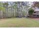 Spacious backyard with a firepit, play area, and hot tub perfect for outdoor activities at 657 Swans Landing Dr, Dacula, GA 30019